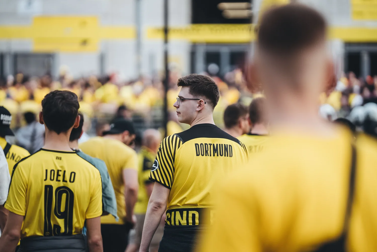 Fußballfans in gelben Borussia Dortmund Trikots vor dem Signal Iduna Park, Menschenmenge und Fan-Atmosphäre