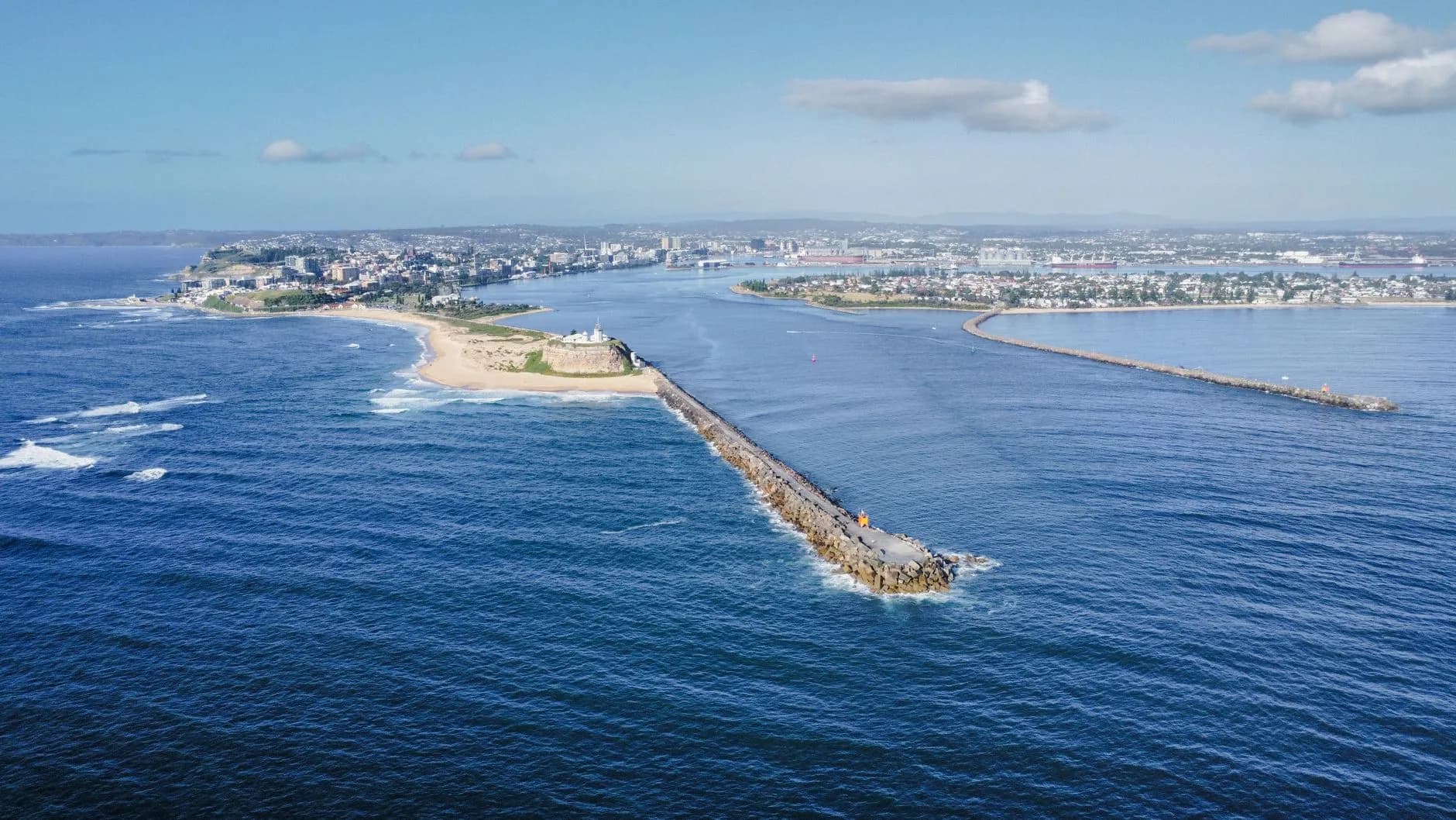 Stunning aerial shot of Newcastle's coastline, harbor, and historic Newcastle Breakwall.