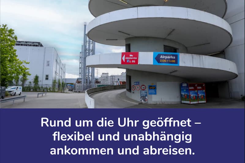 Spiralförmige Rampe eines Parkhauses mit Airparks-Schild, Zufahrt, Automaten und Industriegebäuden im Hintergrund.